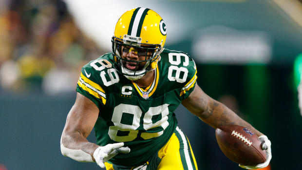 Marcedes Lewis runs with the football.